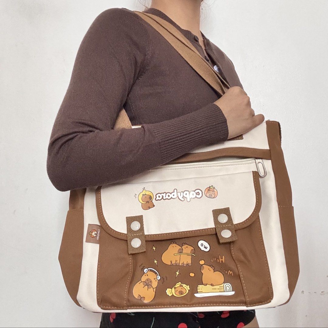 Cute Capybara Canvas Multi-Pocket Tote & Sling Bag (Category: Tote Bags) located in Las Pinas. Submitted by mewmento (Listing ID 1444543676, Image 1). Description: Cute Capybara Canvas Multi-Pocket Tote & Sling Bag • Casual, cute, and functional utility vibe • Durable, structured canvas fabric with multiple easy-access compartments • Easy to style for casual school, office, or everyday commutes 📌 Brand: Unbranded / Custom Cute Print 📌 Condition