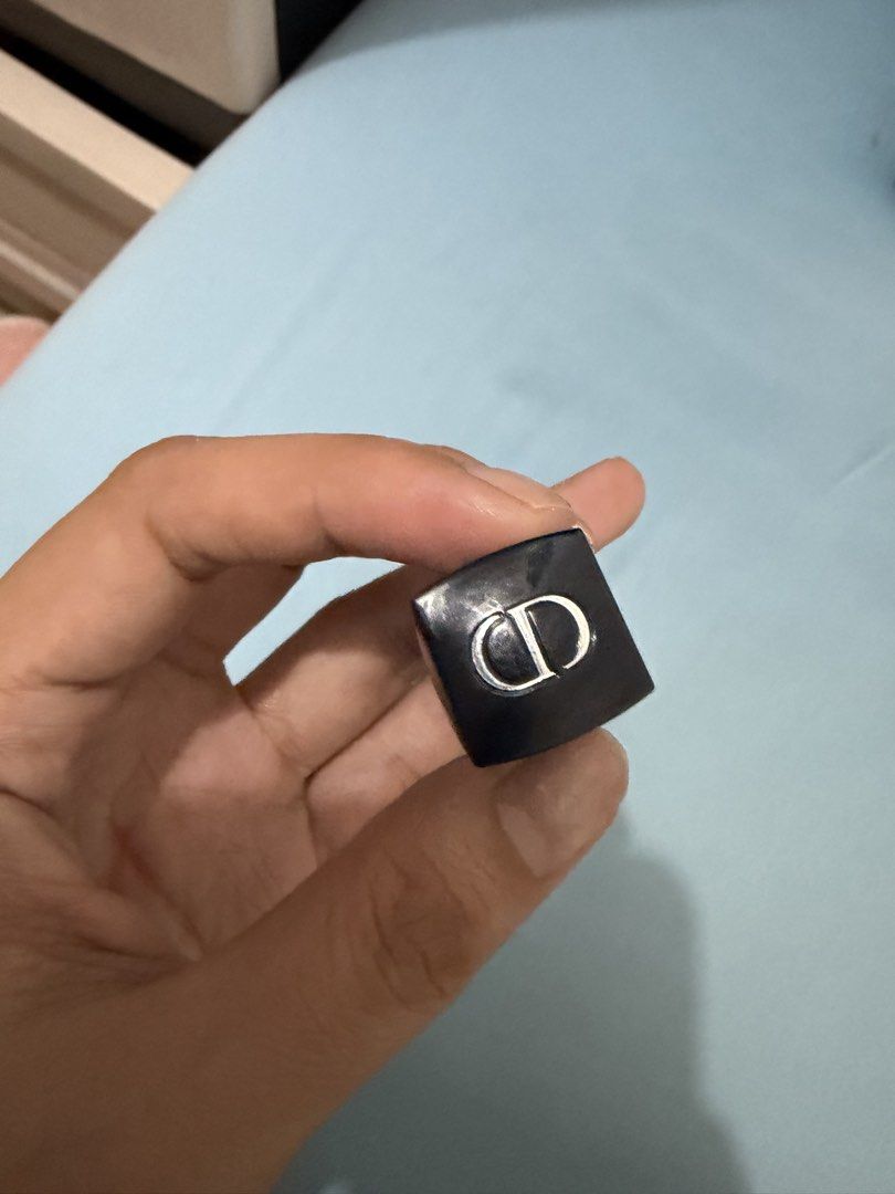 Dior Rouge Dior Lipstick (Category: Makeup) located in Davao. Submitted by fabdeclutter (Listing ID 1444654847, Image 2). Description: - Authentic Dior lipstick - Classic black case with CD logo - Shade: Nude-brown - Lightly used, plenty of product remaining - Case shows minor signs of wear - Ideal for everyday wear or subtle glam looks.