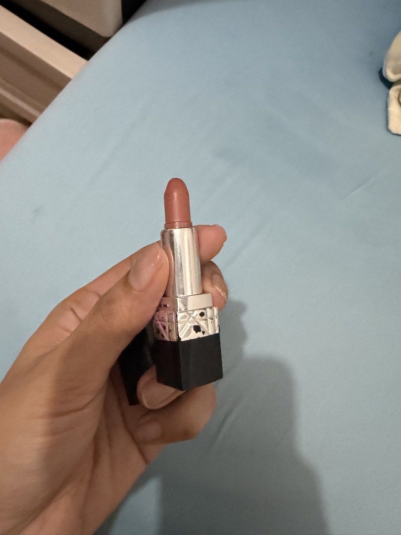 Dior Rouge Dior Lipstick (Category: Makeup) located in Davao. Submitted by fabdeclutter (Listing ID 1444654847, Image 3). Description: - Authentic Dior lipstick - Classic black case with CD logo - Shade: Nude-brown - Lightly used, plenty of product remaining - Case shows minor signs of wear - Ideal for everyday wear or subtle glam looks.