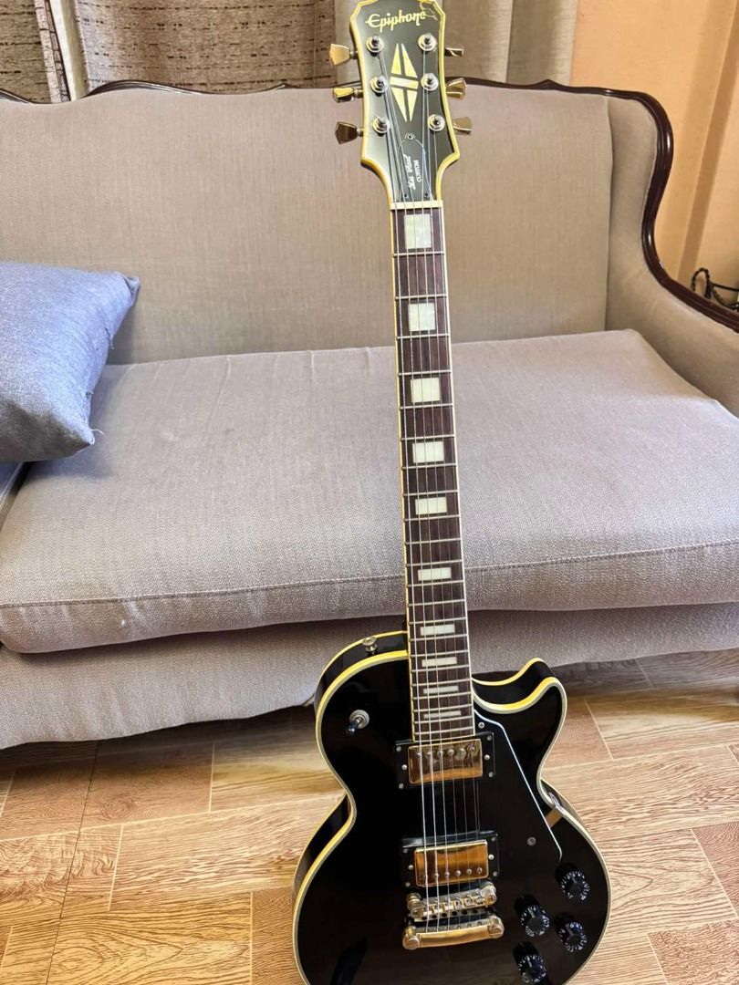 Epiphone Les Paul Custom Electric Guitar - Black (Category: Musical Instruments) located in Caloocan City. Submitted by mightywater_71bc75 (Listing ID 1444510635, Image 1). Description: - Black Epiphone Les Paul Custom electric guitar - Hardware oxidizing - great player guitar - Good fret life - Signs of use - Headstock finish chip repaired.