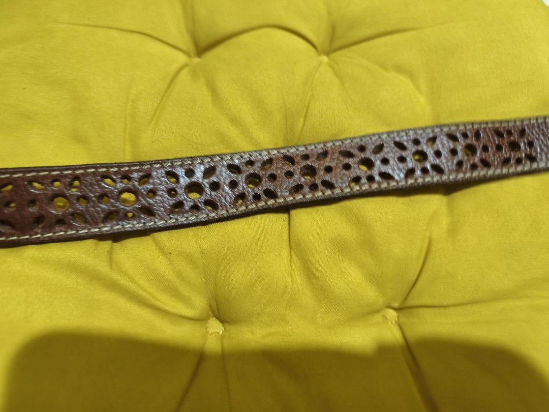 F933 Brown Leather Belt with Cutout Design (Category: Belts) located in La Paz. Submitted by carou89146 (Listing ID 1444641916, Image 3). Description: This belt is one of the nicest in my collections - Classic brown leather belt - Unique cutout pattern along the length - Textured leather finish - Silver-toned buckle - Perfect for casual or dressy outfits - Adds a stylish detail to any look length 41.5 size fits up to the tip,hole all the way up t