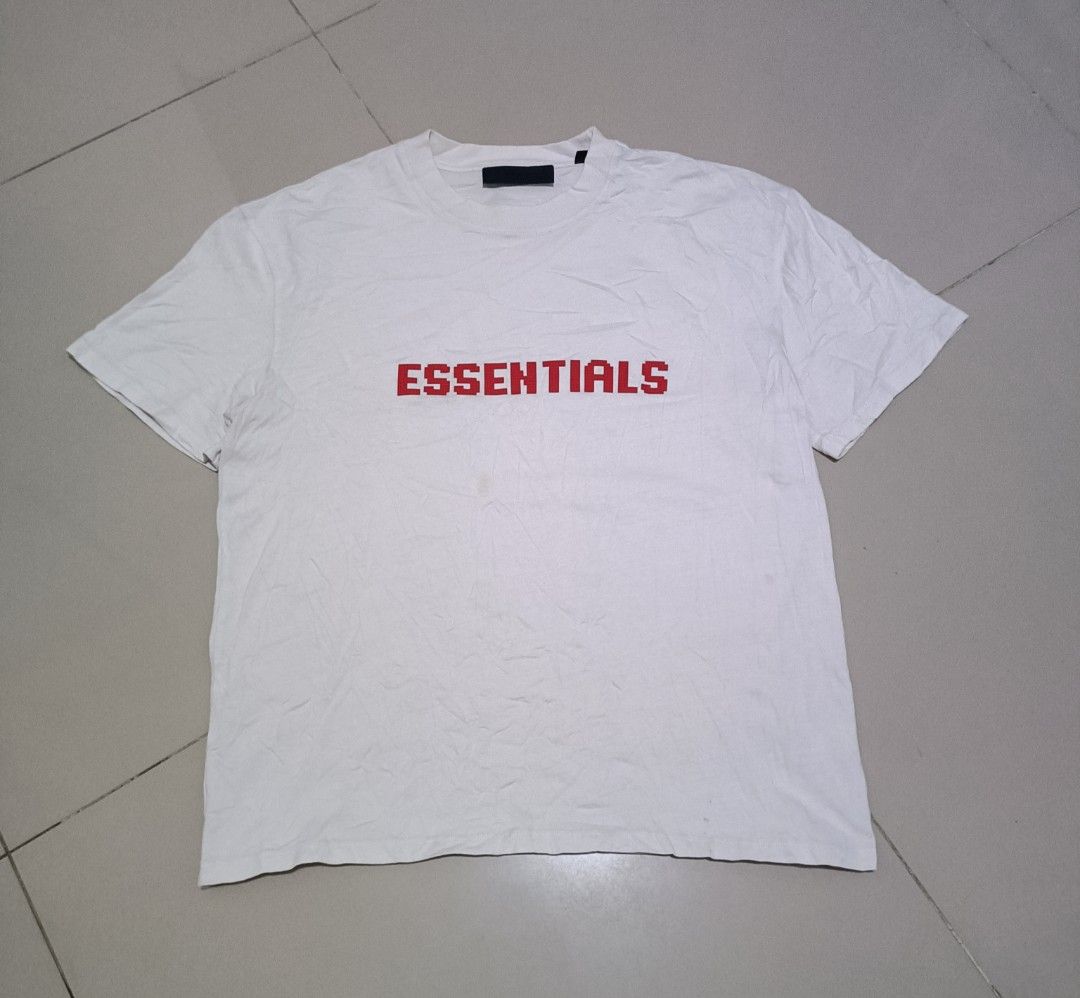 Fear of God Essentials White Red Logo T-Shirt (Category: Tshirts & Polo Shirts ) located in Angeles City. Submitted by jcarino_1822 (Listing ID 1444614339, Image 1). Description: - White Fear of God Essentials T-shirt - Red pixelated logo graphic on the front - Standard crew neck, short sleeves - Ideal for casual everyday wear.
