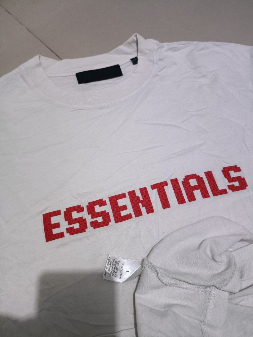 Fear of God Essentials White Red Logo T-Shirt (Category: Tshirts & Polo Shirts ) located in Angeles City. Submitted by jcarino_1822 (Listing ID 1444614339, Image 2). Description: - White Fear of God Essentials T-shirt - Red pixelated logo graphic on the front - Standard crew neck, short sleeves - Ideal for casual everyday wear.
