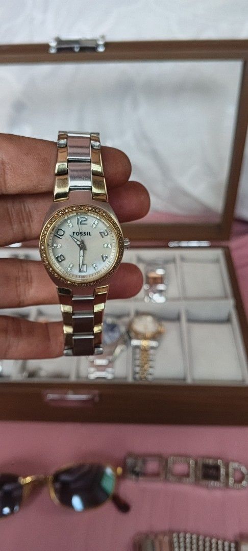 Fossil Two-Tone Watch with Crystal Bezel (Category: Women's Watches) located in Dasmarinas. Submitted by MVB0505 (Listing ID 1444511655, Image 1). Description: - Fossil Two-Tone Stainless Steel Watch - Band: Silver and Gold finish - Dial: White with crystal accents around the bezel - Display: Classic analog with number markers - Closure: Secure clasp - Style: Elegant and versatile, ideal for everyday wear..complete stone.