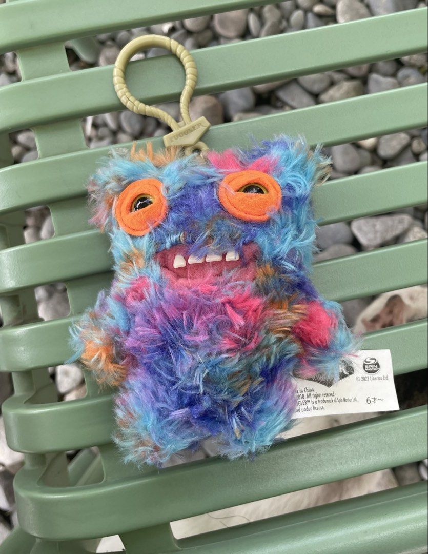 Fuggler Mr Buttons (Category: Plushies & Soft Toys) located in Dagupan City. Submitted by drg.carousel (Listing ID 1444589848, Image 1). Description: - Adorable fuzzy monster keychain - Vibrant tie-dye pattern: blue, pink, and orange - Cute details: big orange eyes and a small mouth with teeth - Comes with a loop and clip for versatile attachment - Perfect accessory for bags or keys.