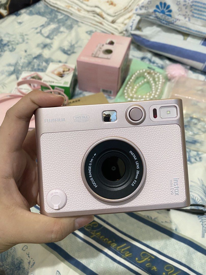 Fujifilm Instax Mini Evo Pink Camera Bundle with Accessories (Category: Cameras) located in Cabanatuan. Submitted by therrr706 (Listing ID 1444548657, Image 3). Description: - Fujifilm Instax Mini Evo Camera (Pink) - Pink Camera Bag and Strap - Instax Mini Pink Lemonade Film (1 pack) - Two (2) Clear Camera Cases - 32GB Memory Card - Tempered Glass Screen Protector - Pearl Necklace - Pink Keychain - Ideal for instant photography enthusiasts!.