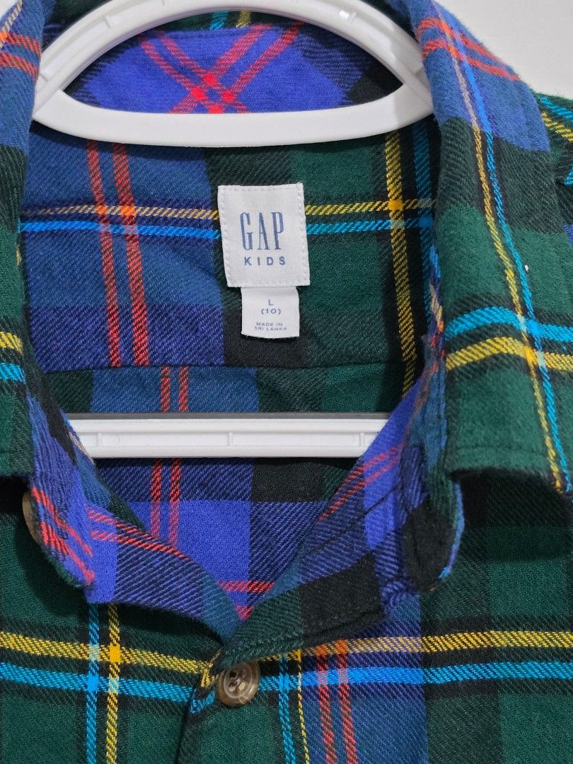 GAP Kids Plaid Flannel Shirt (Category: Babies & Kids Fashion) located in Quezon City. Submitted by luisclosetph (Listing ID 1444649526, Image 2). Description: - Classic plaid flannel shirt from GAP Kids - Features a green, blue, and yellow plaid pattern - Long sleeves with button cuffs - Includes a chest pocket - Soft and comfortable material, perfect for layering or standalone wear.