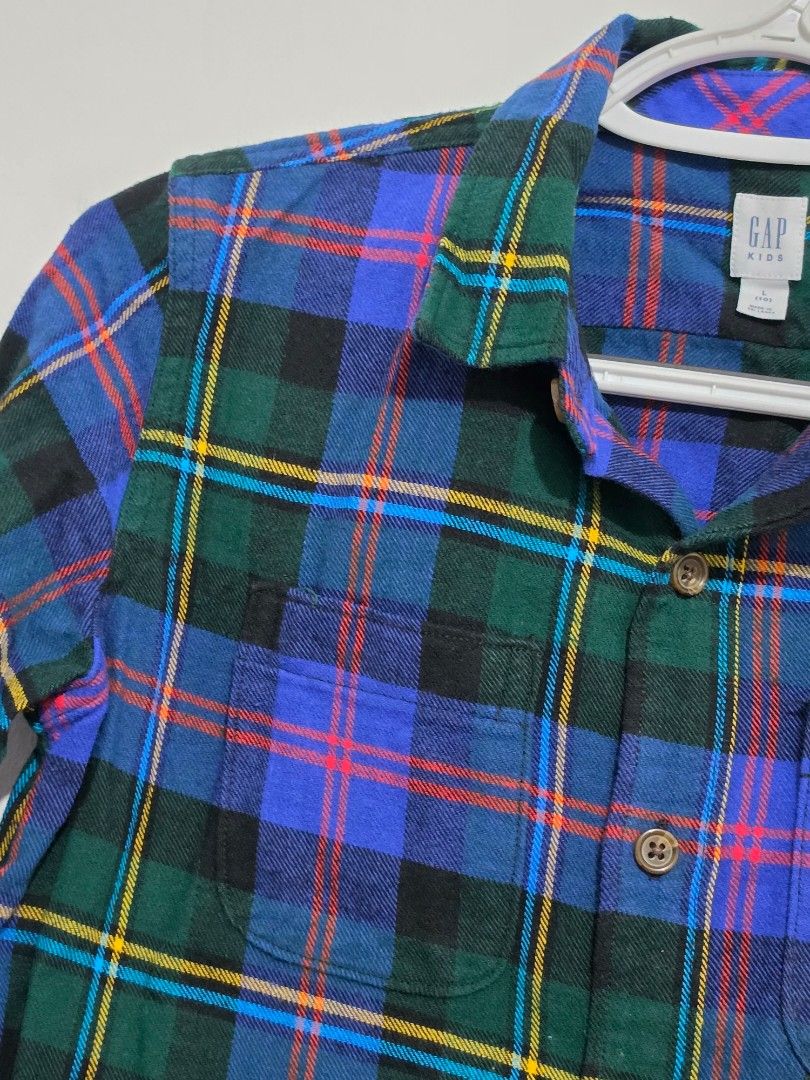 GAP Kids Plaid Flannel Shirt (Category: Babies & Kids Fashion) located in Quezon City. Submitted by luisclosetph (Listing ID 1444649526, Image 3). Description: - Classic plaid flannel shirt from GAP Kids - Features a green, blue, and yellow plaid pattern - Long sleeves with button cuffs - Includes a chest pocket - Soft and comfortable material, perfect for layering or standalone wear.