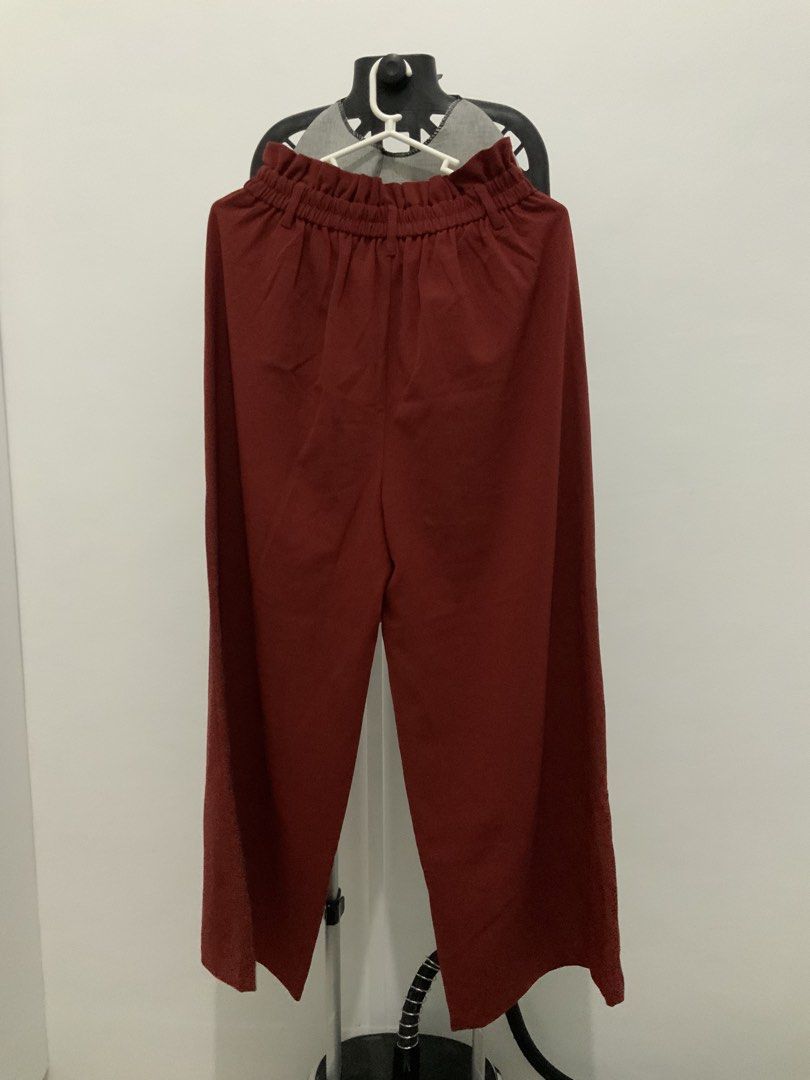 GU Wide Leg Pants - Red Color (Category: Other Bottoms) located in Taguig. Submitted by mstyphoon (Listing ID 1444535459, Image 3). Description: - Red colored wide leg pants from GU - Elastic waistband with ruffled detail - Cropped length - Made from a comfortable polyester blend - Perfect for stylish everyday wear - Versatile and easy to pair with various tops.