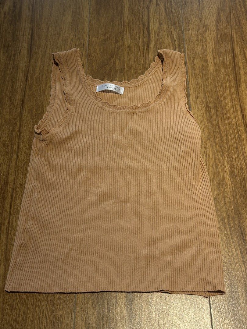 Guan Studio Ribbed Tank Top - Brown (Category: Sleeveless) located in Cebu City. Submitted by wear.marie (Listing ID 1444549531, Image 1). Description: - Brand: Guan Studio - Color: Brown - Material: Ribbed fabric - Neckline: Scalloped - Armholes: Scalloped - Sleeves: Sleeveless - Style: Comfortable and versatile for layering or casual outfits.