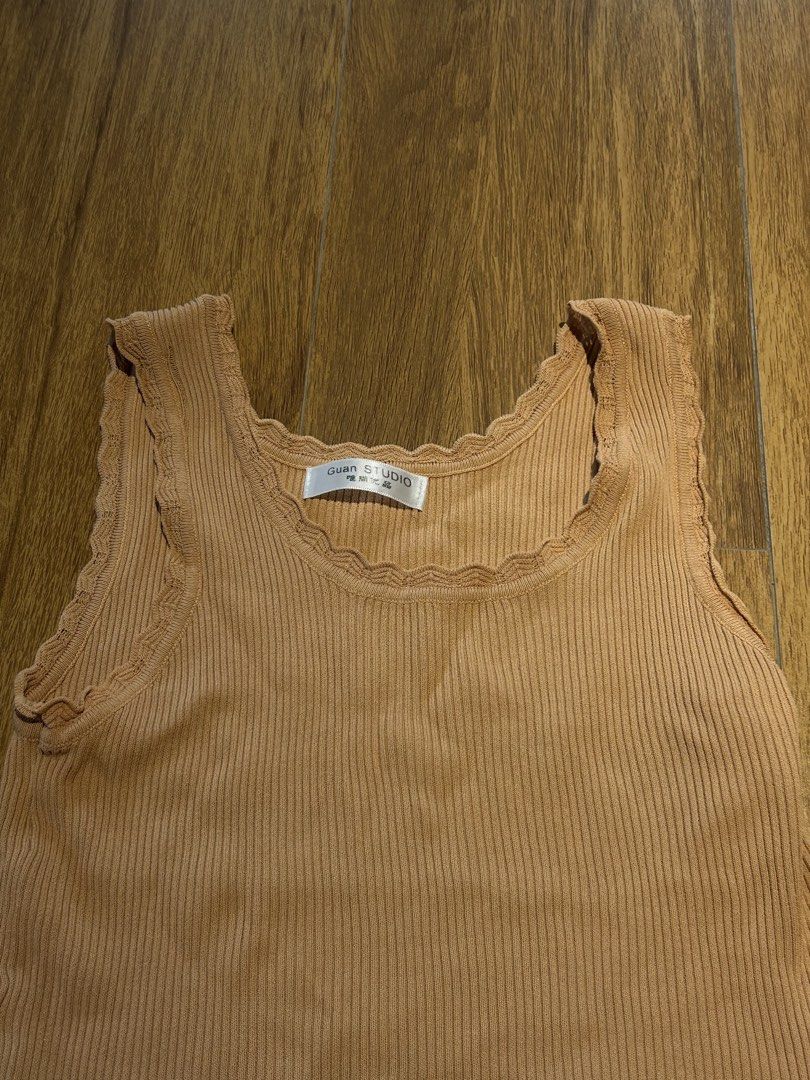 Guan Studio Ribbed Tank Top - Brown (Category: Sleeveless) located in Cebu City. Submitted by wear.marie (Listing ID 1444549531, Image 3). Description: - Brand: Guan Studio - Color: Brown - Material: Ribbed fabric - Neckline: Scalloped - Armholes: Scalloped - Sleeves: Sleeveless - Style: Comfortable and versatile for layering or casual outfits.