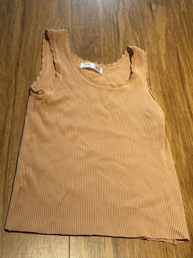 Guan Studio Ribbed Tank Top - Brown (Category: Sleeveless) located in Cebu City. Submitted by wear.marie (Listing ID 1444549531, Image 2). Description: - Brand: Guan Studio - Color: Brown - Material: Ribbed fabric - Neckline: Scalloped - Armholes: Scalloped - Sleeves: Sleeveless - Style: Comfortable and versatile for layering or casual outfits.