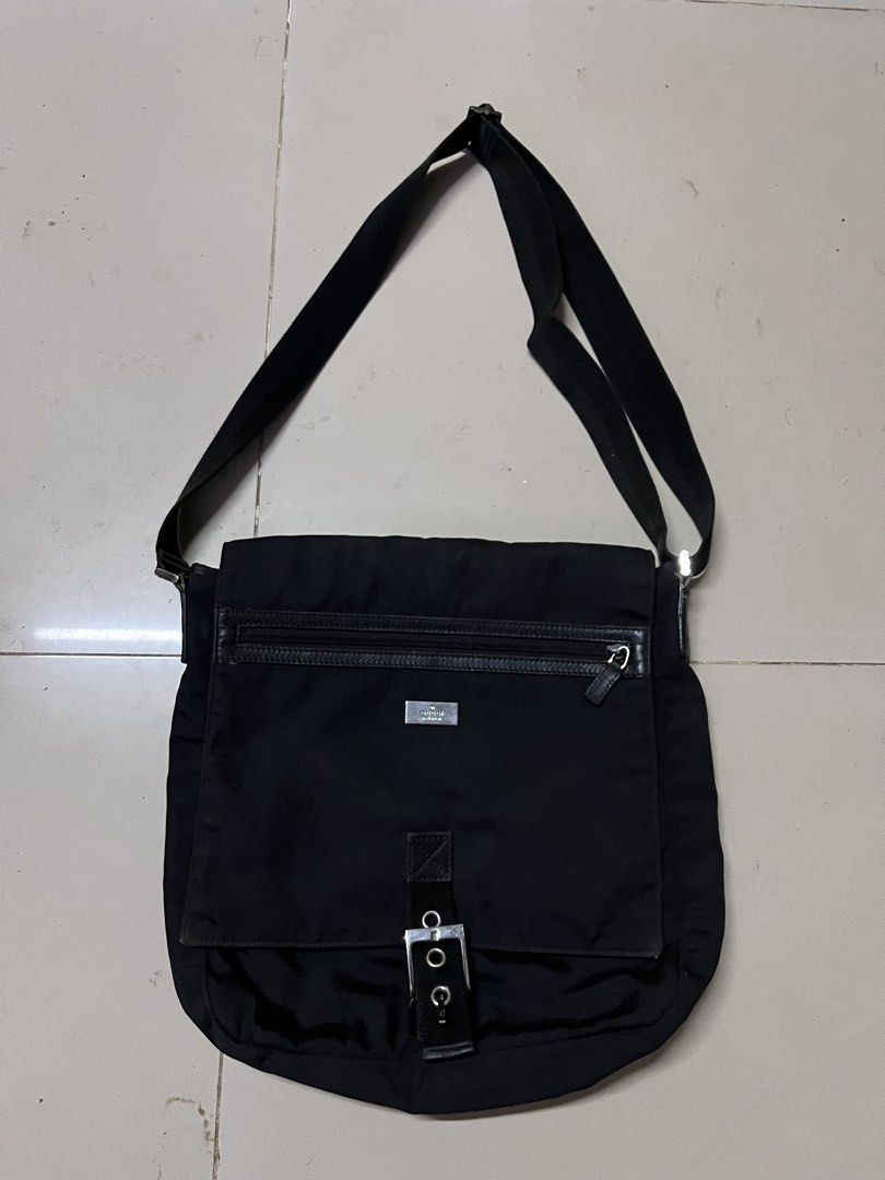 Gucci Black Nylon Messenger Bag (Category: Luxury Bags & Wallets) located in Manila. Submitted by jj_thrift (Listing ID 1444616145, Image 1). Description: - Authentic Gucci messenger bag - Made in Italy - Durable nylon with leather trim - Adjustable strap for comfortable wear - Main zip compartment - Front flap pocket with buckle closure - Metal Gucci logo plate on front - Gucci logo on zipper pull - Minor signs of wear on hardware.