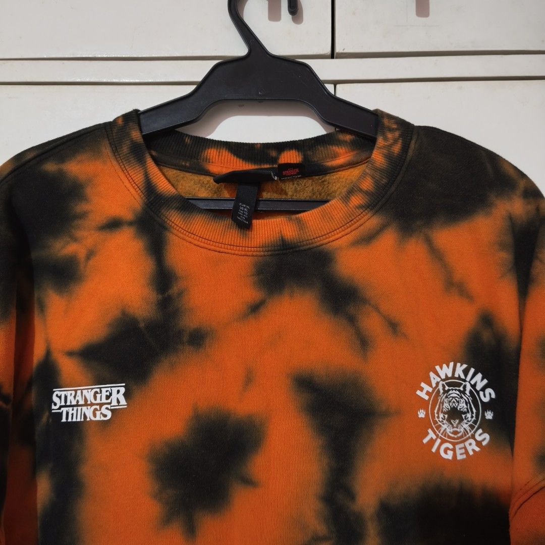 H&M Stranger Things Tie-Dye Oversized Fit Sweatshirt (Category: Longsleeves) located in Manila. Submitted by iyyuuuuuuuuh (Listing ID 1444669957, Image 3). Description: H&M x Stranger Things and Hawkins Tigers graphics Oversized fit, size XL. Very pretty .