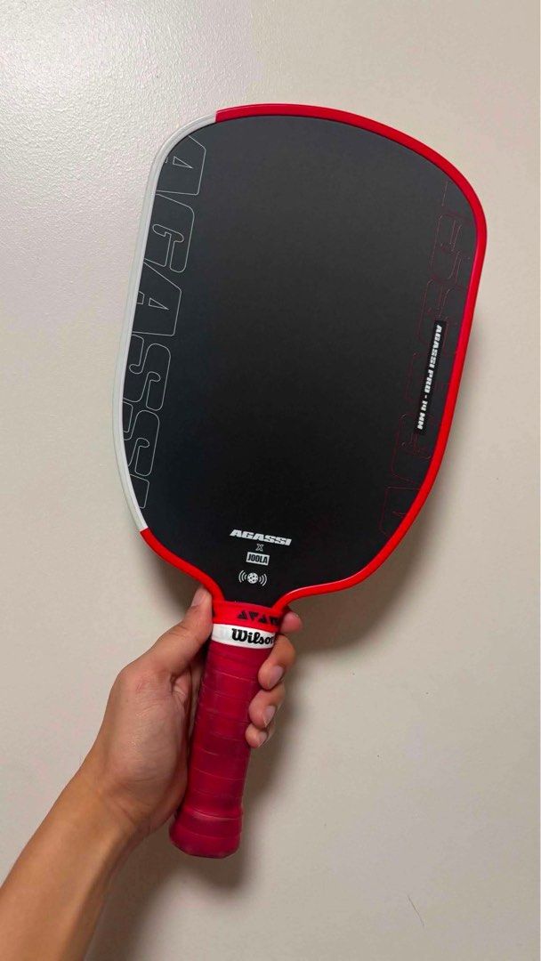 Joola Agassi Pro Pickleball Paddle (Category: Racket and Ball Sports) located in Makati City. Submitted by paudasilva (Listing ID 1444647615, Image 2). Description: - Agassi pickleball paddle - Stylish red and black design - USA-A approved for official play - Comfortable red Wilson handle - Perfect for your next pickleball match.
