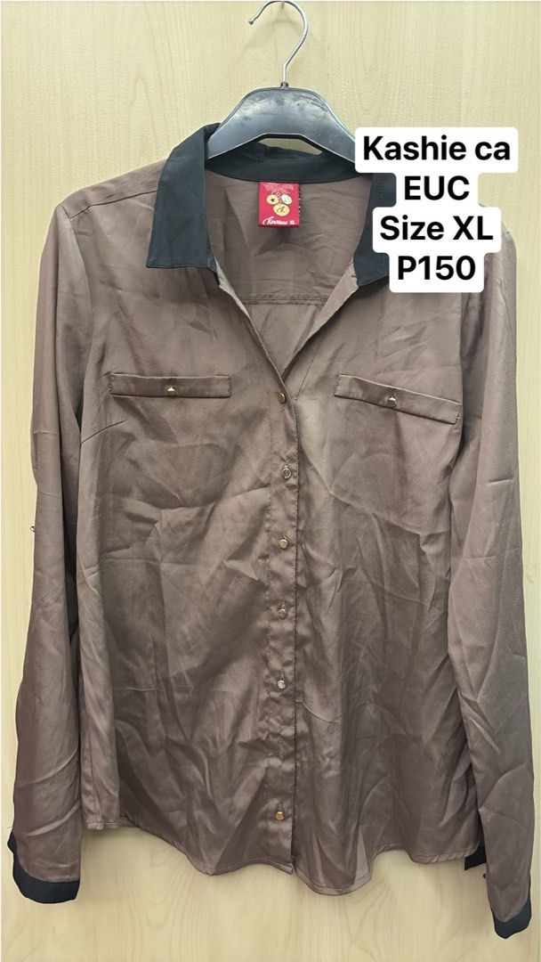 Kashieca Brown Button-Up Shirt XL (Category: Shirts) located in Quezon City. Submitted by shoppingtime_mnl (Listing ID 1444578568, Image 1). Description: - Brand: Kashieca - Color: Brown - Style: Button-up shirt - Size: XL - Details: Black collar, black cuffs, two chest pockets with button accents - Occasion: Suitable for casual or semi-formal wear.
