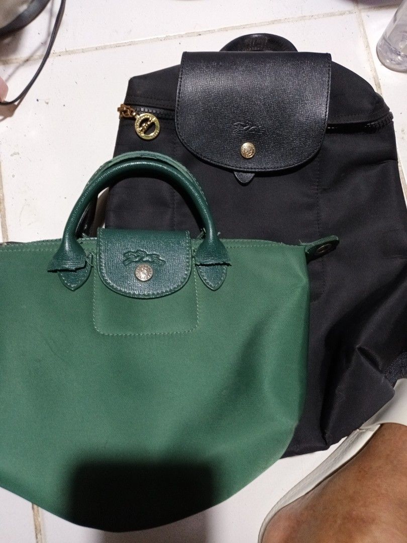 Longchamp Backpack and Handbag Set (Category: Luxury Bags & Wallets) located in Manila. Submitted by gentledog.819ff9 (Listing ID 1444591180, Image 1). Description: - Set includes a classic black Longchamp backpack and a green Longchamp handbag. - Backpack features a leather flap closure. - Handbag has top handles and a flap closure. - Ideal for everyday use or travel..