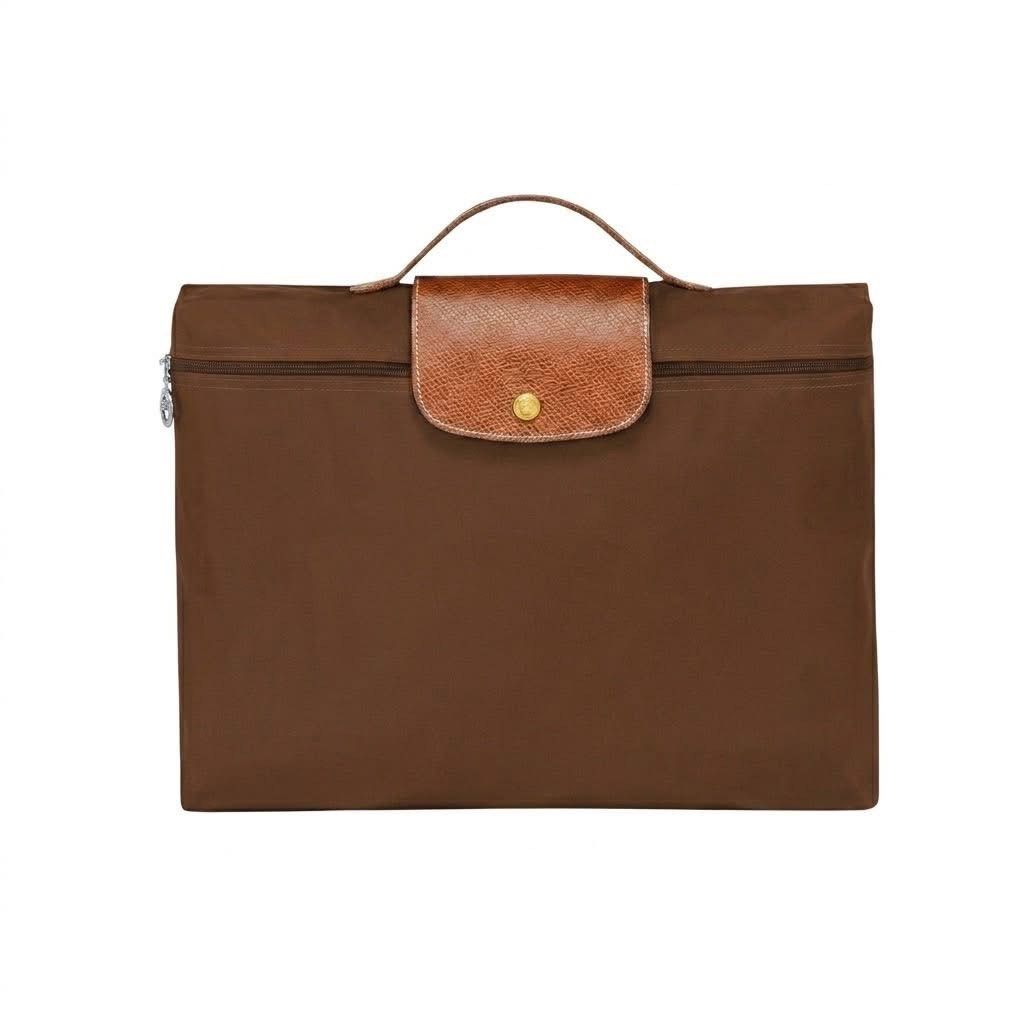 Longchamp Le Pliage Briefcase Laptop Bag (Category: Luxury Bags & Wallets) located in Quezon City. Submitted by mnl.drops (Listing ID 1429527229, Image 2). Description: 𝐋𝐨𝐧𝐠𝐜𝐡𝐚𝐦𝐩 𝐋𝐞 𝐏𝐥𝐢𝐚𝐠𝐞 𝐁𝐫𝐢𝐞𝐟𝐜𝐚𝐬𝐞 Unisex Outlet-sourced On-hand Ready-to-ship ▪️L: 37 cm × H: 28 cm × W: 8 cm ▪️Snap button ▪️Zip closure ▪️Color: Navy Blue, Black, Brown ▪️Can fit 15 inch laptop.