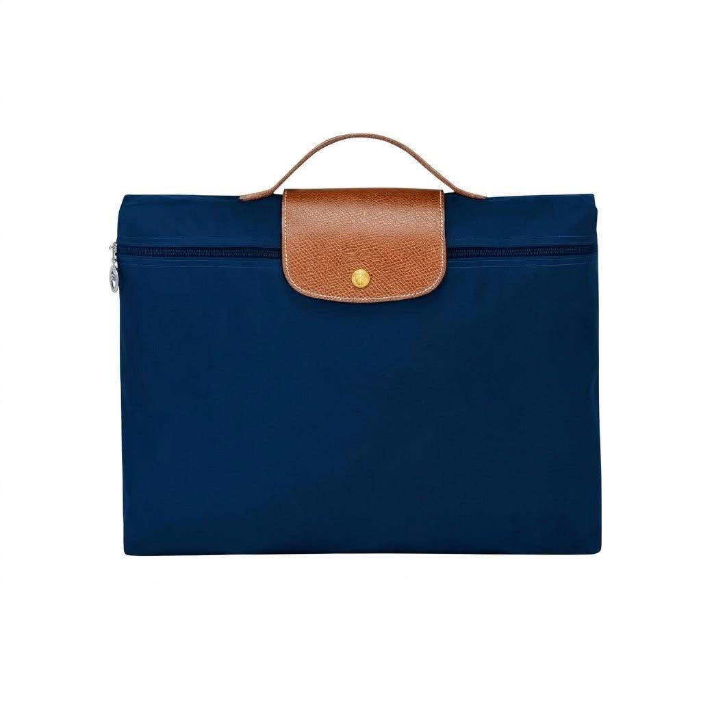 Longchamp Le Pliage Briefcase Laptop Bag (Category: Luxury Bags & Wallets) located in Quezon City. Submitted by mnl.drops (Listing ID 1429527229, Image 3). Description: 𝐋𝐨𝐧𝐠𝐜𝐡𝐚𝐦𝐩 𝐋𝐞 𝐏𝐥𝐢𝐚𝐠𝐞 𝐁𝐫𝐢𝐞𝐟𝐜𝐚𝐬𝐞 Unisex Outlet-sourced On-hand Ready-to-ship ▪️L: 37 cm × H: 28 cm × W: 8 cm ▪️Snap button ▪️Zip closure ▪️Color: Navy Blue, Black, Brown ▪️Can fit 15 inch laptop.