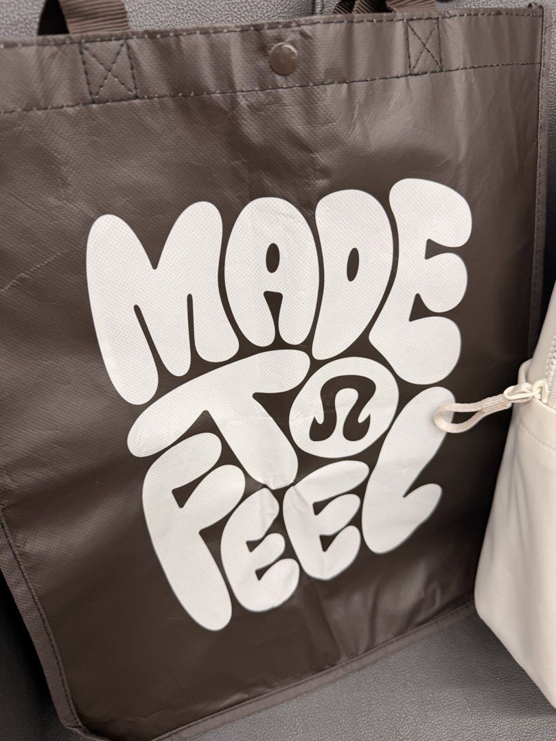 Lululemon Cream Backpack & "Made to Feel" Tote Bag (Category: Backpacks) located in Quezon City. Submitted by ellamenopi (Listing ID 1444502575, Image 2). Description: - Set includes: Cream Lululemon backpack and brown "Made to Feel" Lululemon tote bag. - Lululemon backpack features a front zip pocket and main compartment. - Tote bag has brown color with white text and Lululemon logo. - Both bags are ideal for everyday use..