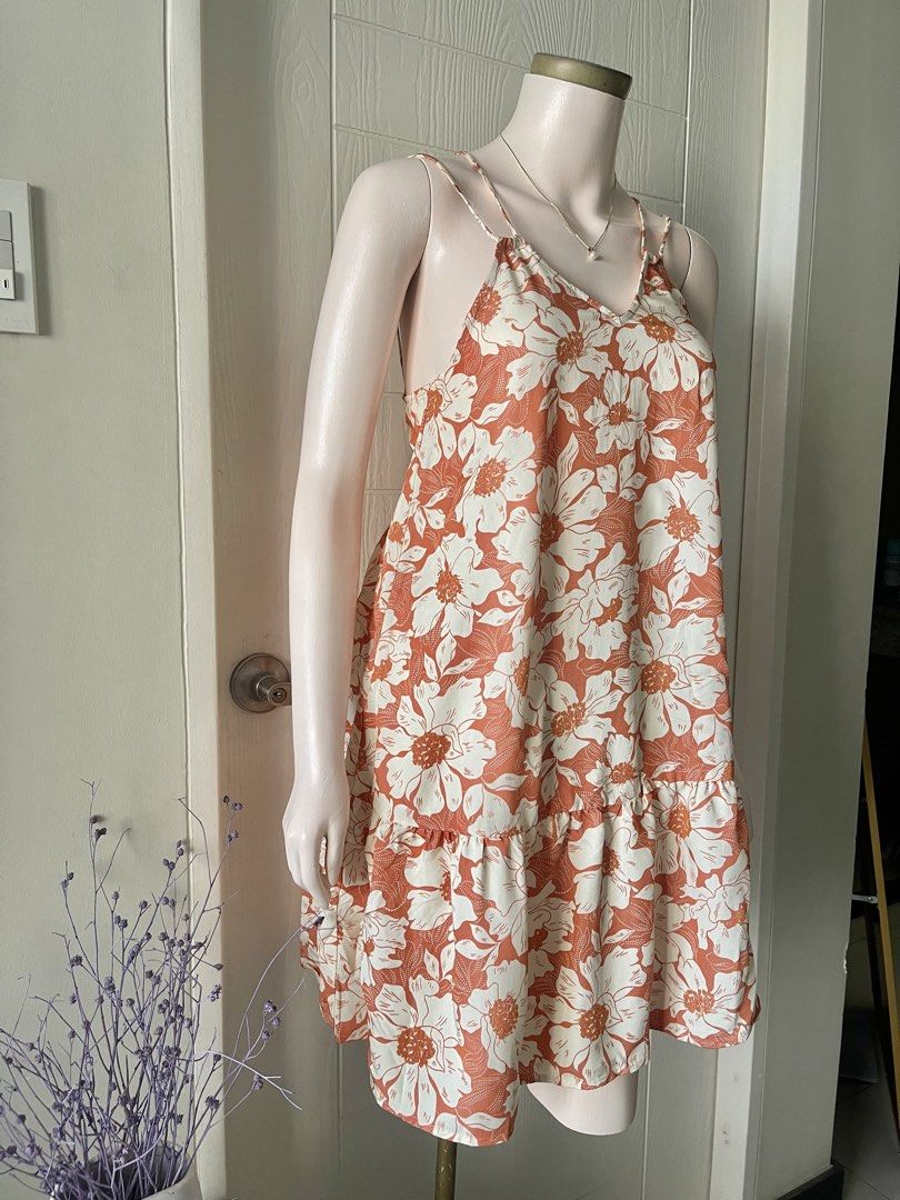 MANGO Mini Dress with Criss-Cross Back Straps (Category: Dresses) located in Mandaluyong City. Submitted by iamprettywow (Listing ID 1444567276, Image 2). Description: - Actual Photo posted -What you see is What you get - XS in size but fit up to medium 38 bust Mannequin size is Small 5’4 height - Adorable orange and white floral print mini dress - Features delicate spaghetti straps with a stylish criss-cross back detail - Flattering tiered hemli