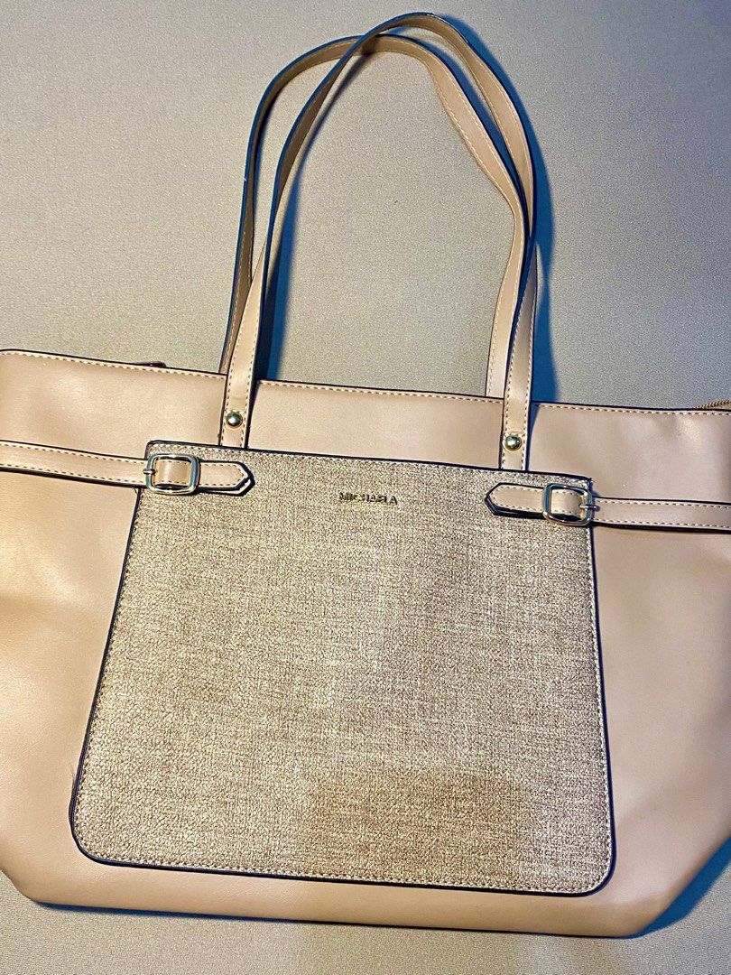 Michaela Tote Bag - Beige with Gold Accent (Category: Tote Bags) located in Makati City. Submitted by style__snap (Listing ID 1444542872, Image 3). Description: 100% original Beige Michaela tote bag - Textured gold panel with buckle details on the front - Interior lining features all-over Michaela logo print - Ample space for essentials - Ideal for everyday use or work tote bag can fit laptop and ipad.
