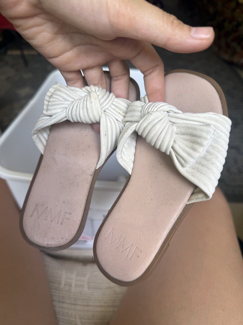 MMF White Knotted Slide Sandals Size 23 (Category: Babies & Kids Fashion) located in Pasig City. Submitted by atticfindsqc (Listing ID 1444519322, Image 1). Description: - White KMF slide sandals - Features a cute knotted detail on the strap - Size 23 - Insole embossed with MMF logo - Easy to slip on and off Sole length 7 inches.