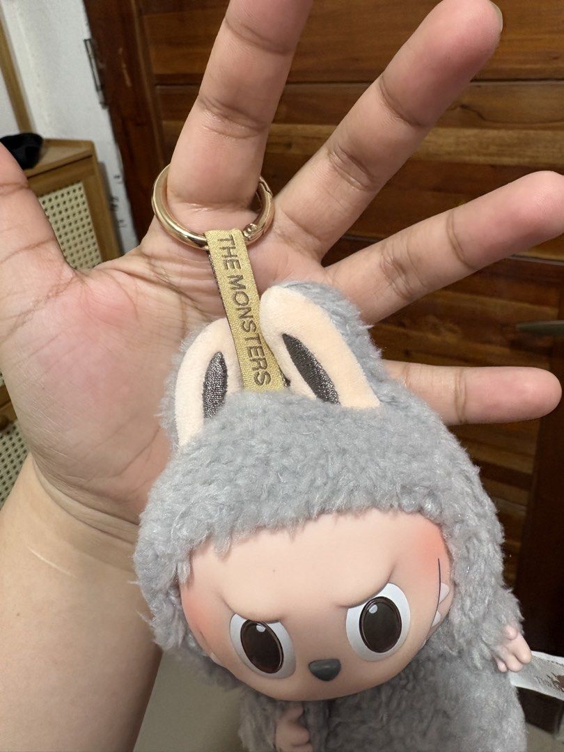 Original Pop Mart Labubu V1 sesame bean (Category: Plushies & Soft Toys) located in Santa Cruz. Submitted by rosie0601 (Listing ID 1444499201, Image 3). Description: - Cute Labubu plush keychain - From Pop Mart's The Monsters series - Soft and fuzzy grey material - Features a keychain ring - Ideal for decorating bags or keys.