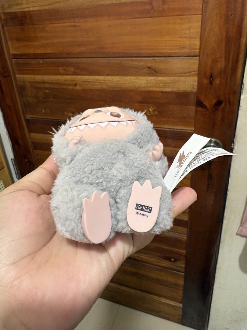 Original Pop Mart Labubu V1 sesame bean (Category: Plushies & Soft Toys) located in Santa Cruz. Submitted by rosie0601 (Listing ID 1444499201, Image 2). Description: - Cute Labubu plush keychain - From Pop Mart's The Monsters series - Soft and fuzzy grey material - Features a keychain ring - Ideal for decorating bags or keys.