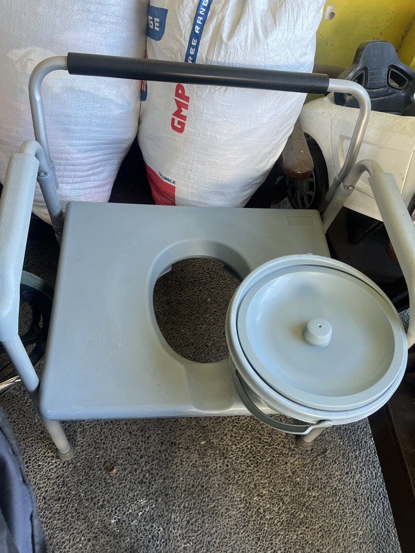 Portable Commode Chair with Bucket (Category: Medical Supplies & Tools) located in Makati City. Submitted by myleen0411 (Listing ID 1444579901, Image 2). Description: - Portable commode chair - Gray seat and armrests - Sturdy metal frame - Includes removable bucket with lid - Easy to move around - Perfect for elderly or individuals needing assistance.