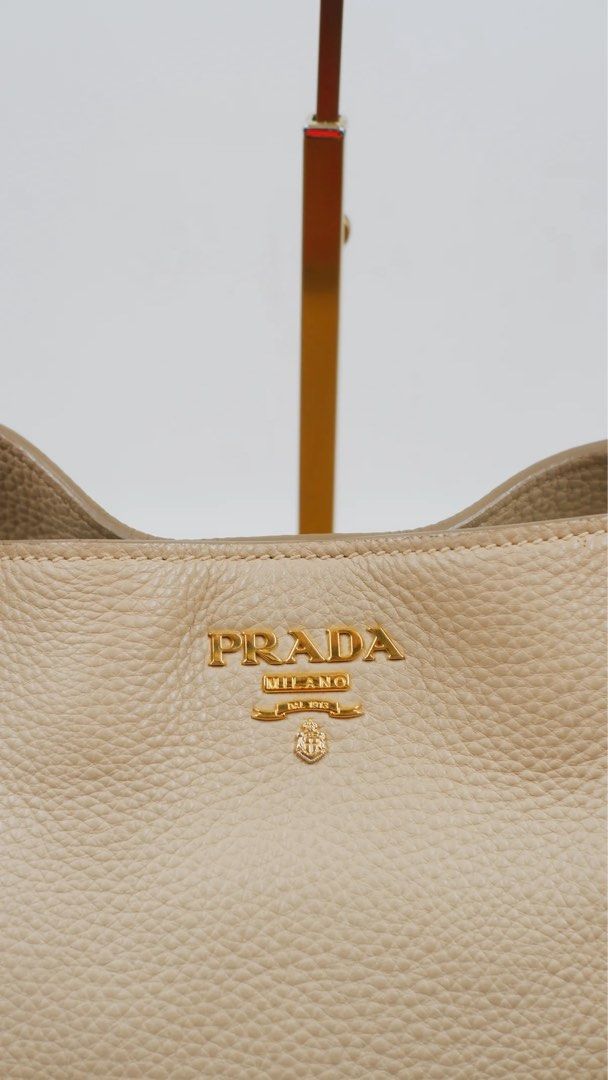 Prada Beige Leather Tote Bag (Category: Luxury Bags & Wallets) located in Manila. Submitted by camillecaf29057 (Listing ID 1444585583, Image 2). Description: - Authentic Prada tote bag - Beige pebbled leather - Gold hardware details - Spacious interior with zip closure - Comes with Prada dust bag - Ideal for everyday essentials.