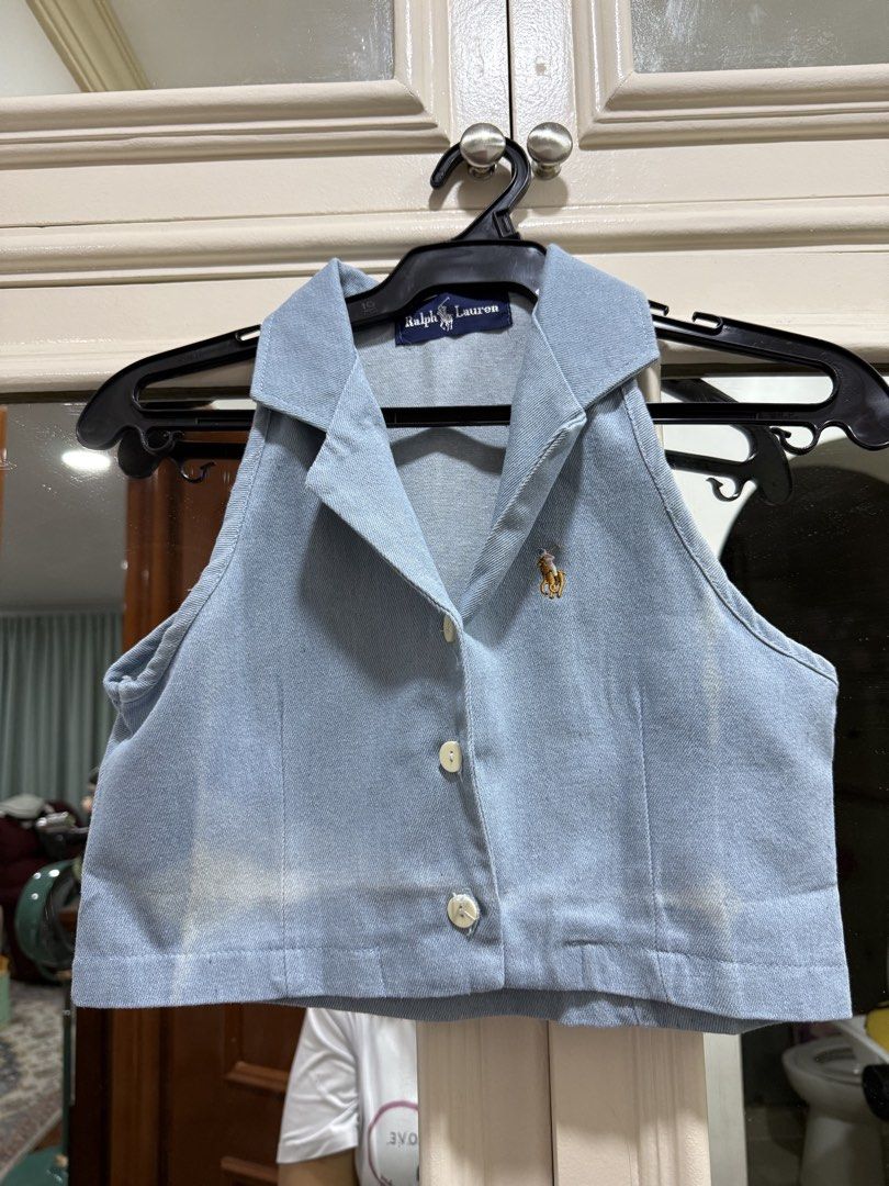 Ralph Lauren Denim Halter Crop Top (Category: Sleeveless) located in Quezon City. Submitted by jiafoo (Listing ID 1444613921, Image 2). Description: - Brand: Ralph Lauren - Style: Light wash denim halter top - Neckline: Collared - Closure: Button-up front - Length: Cropped - Details: Embroidered polo player logo on chest - Sleeves: Sleeveless - Occasion: Casual wear.