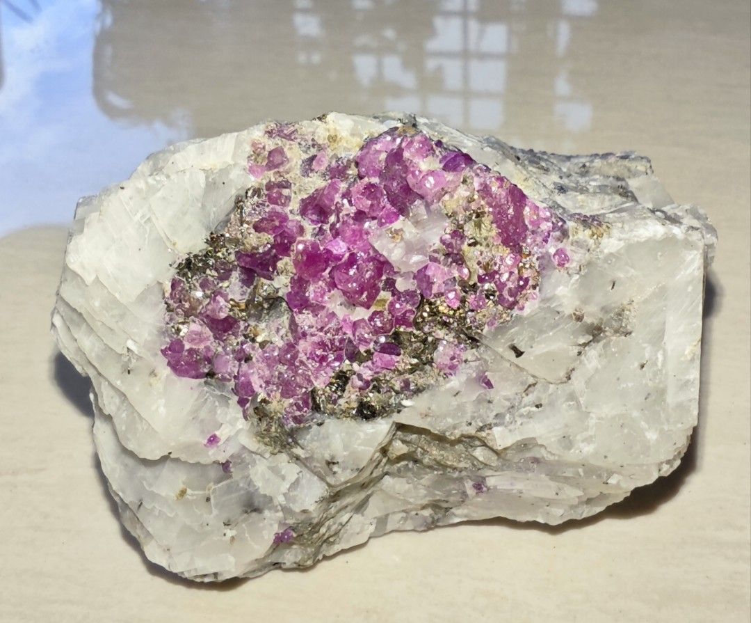 Ruby cluster on matrix (Category: Precious Stones) located in Singapore. Submitted by ys_heng (Listing ID 1444592937, Image 1). Description: - Cluster (4x2cm) of vibrant pink red ruby on matrix from Myanmar - Glows brightly under UV light.