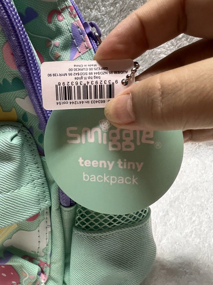 Smiggle Teeny Tiny Backpack - Fun Print (Category: Babies & Kids Fashion) located in Davao. Submitted by kbymonares (Listing ID 1444598506, Image 3). Description: - Adorable Smiggle backpack for little ones. - Fun, colorful print: fruits, ice cream, rainbows. - Color: Mint green with purple accents. - Features: Front pocket, mesh side pockets. - Adjustable straps for a comfy fit. - Ideal size for preschool or day trips..