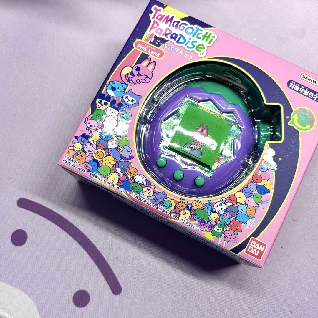 Tamagotchi Paradise Pink Land Virtual Pet (Category: Interactive Toys) located in Manila. Submitted by mcamillevo (Listing ID 1444573503, Image 1). Description: - Tamagotchi Paradise Pink Land virtual pet - Color: Purple with green accents - Features a cute character on screen - Comes in its original box - Swapped the shells SF to be shouldered by buyer, based in Makati.