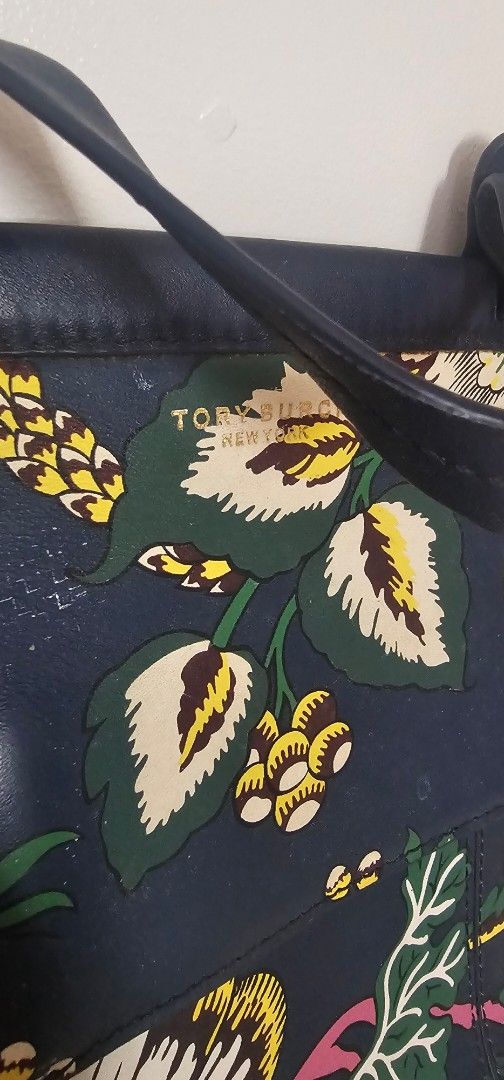Tory Burch Floral Print Tote Bag (Category: Tote Bags) located in Cainta. Submitted by cyjozuza (Listing ID 1444571824, Image 2). Description: - Navy blue Tory Burch tote bag - Beautiful floral print - Genuine leather handles and trim - Multiple interior compartments with zippers - Secure snap closure flap - Ideal for everyday use - No sling - Selling very low.