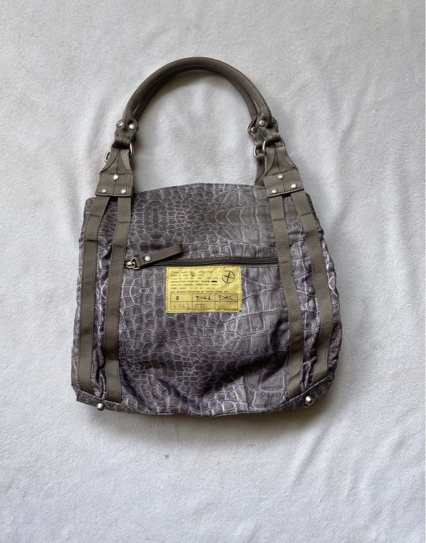 Tough Jeansmith crocskin shoulder bag (Category: Shoulder Bags) located in Makati City. Submitted by ullox (Listing ID 1444541068, Image 2). Description: Cool grey tote bag with croc print. Has zip pockets and buckle details. Vibrant purple interior. Durable fabric, vintage military style. Perfect for daily use..