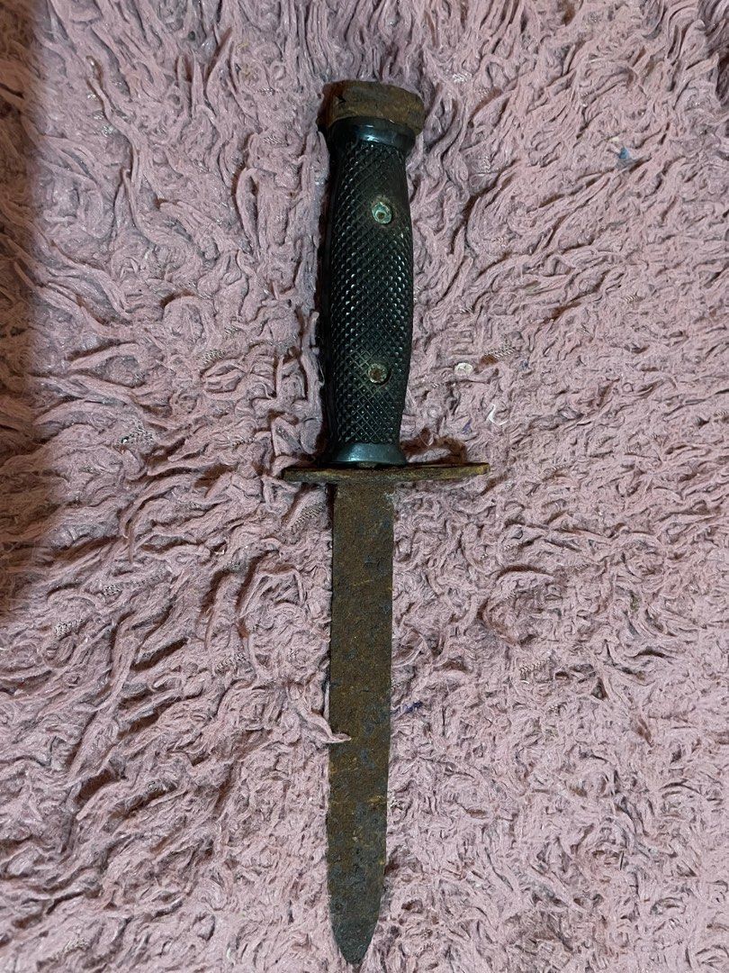 Vintage Bayonet Knife with Black Handle (Category: Vintage Collectibles) located in Dipolog. Submitted by simonpeterdenila (Listing ID 1444605634, Image 2). Description: - Vintage bayonet knife - Shows significant rust and wear - Black textured handle with scuffs - Metal guard and pommel - Blade is dull and pitted - Ideal for display or restoration projects - Ring on guard is intact.