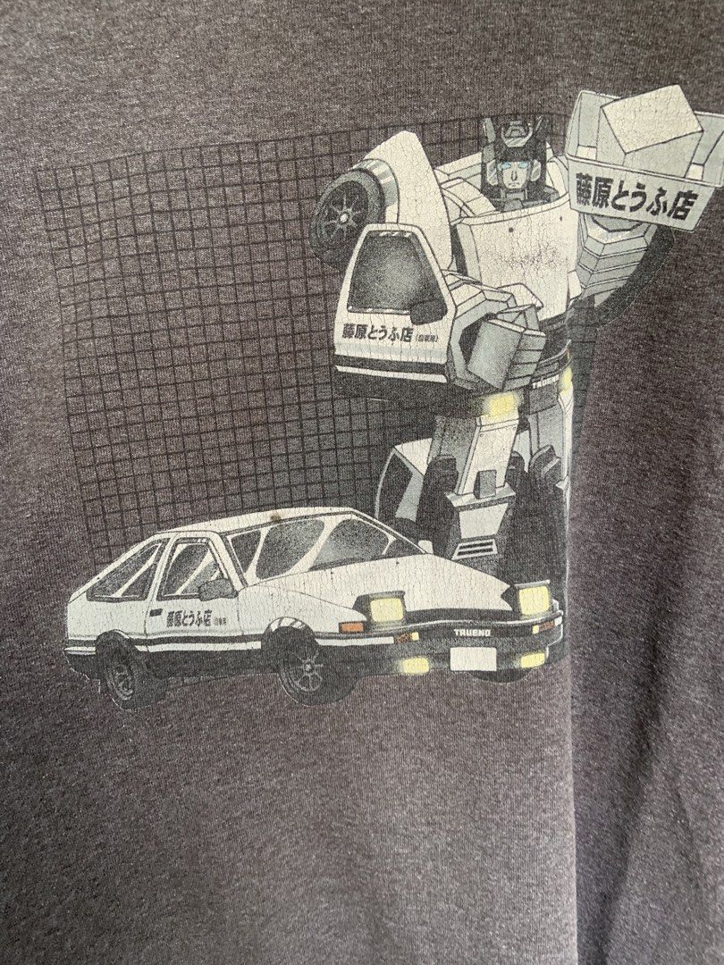 Vintage Initial D x Transformers T-Shirt (23.5x 32) (Category: Tshirts & Polo Shirts ) located in Manila. Submitted by exclusivethreads24 (Listing ID 1444509841, Image 2). Description: -SHOOT YOUR BEST OFFER - Grey t-shirt with a unique graphic print - Features a robot transforming from a car - Design evokes an Initial D and Transformers crossover - Tag is visible for sizing reference - Ideal for fans of anime and mecha genres.