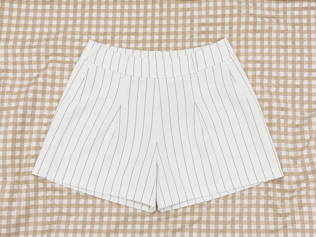 White Pinstripe High-Waisted Shorts (Category: Shorts) located in Iloilo. Submitted by lovedbysachi (Listing ID 1444647124, Image 1). Description: Size: 27-28 - Cute white shorts with subtle thin pinstripes. - Flattering high-waisted design. - Stylish pleated front detail. - Versatile: dress up or down for any occasion. - Ideal for summer wear. - Easy to pair with various tops..