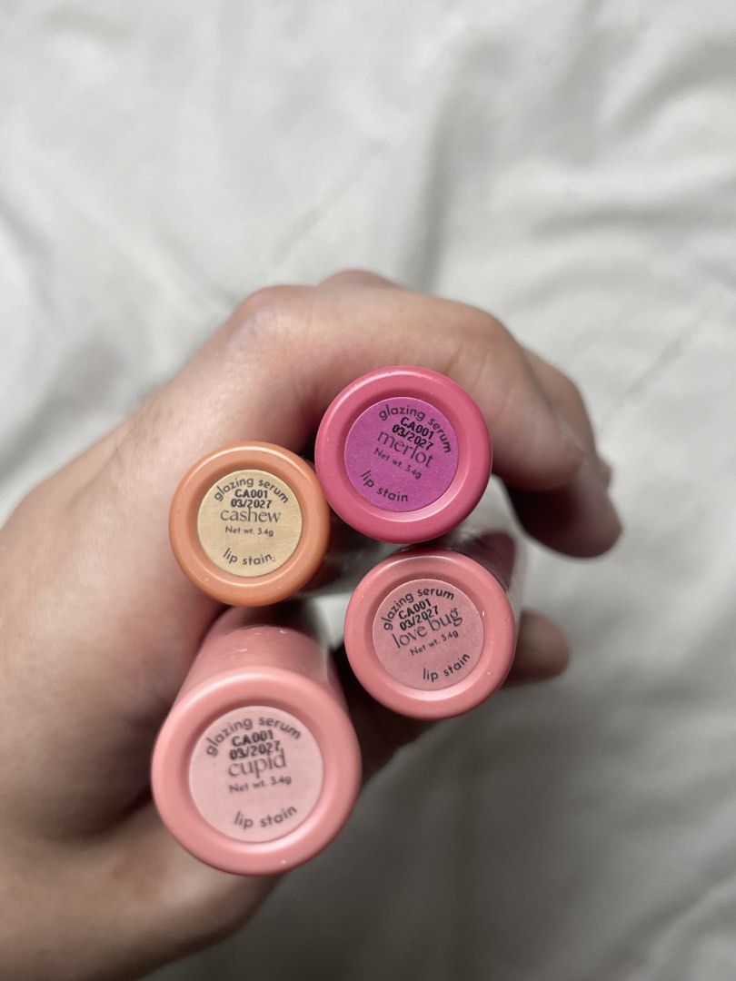 Abstay Glazing Serum Lip Stain (Category: Makeup) located in Abucay. Submitted by declutterwyana (Listing ID 1444774427, Image 2). Description: - ₱199 each - Shades included: Cupid, Love Bug, Cashew, Merlot - Each tube contains 3.4g of product - Provides beautiful, lasting color to your lips.