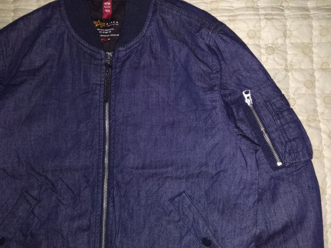 Alpha Industries MA-1 Denin Wash Bomber Jacket (Category: Coats, Jackets and Outerwear) located in Zamboanga. Submitted by zhumhazhav (Listing ID 1444691242, Image 2). Description: - Alpha Industries MA-1 bomber jacket - Dark blue denim wash - A classic MA-1 style - Zippered sleeve pocket - Ribbed collar,cuffs & hem - 2 front pockets with snap closures - Ideal for layering - Versatile wardrobe addition - Size medium tag - Dimensions Width 21 Leng