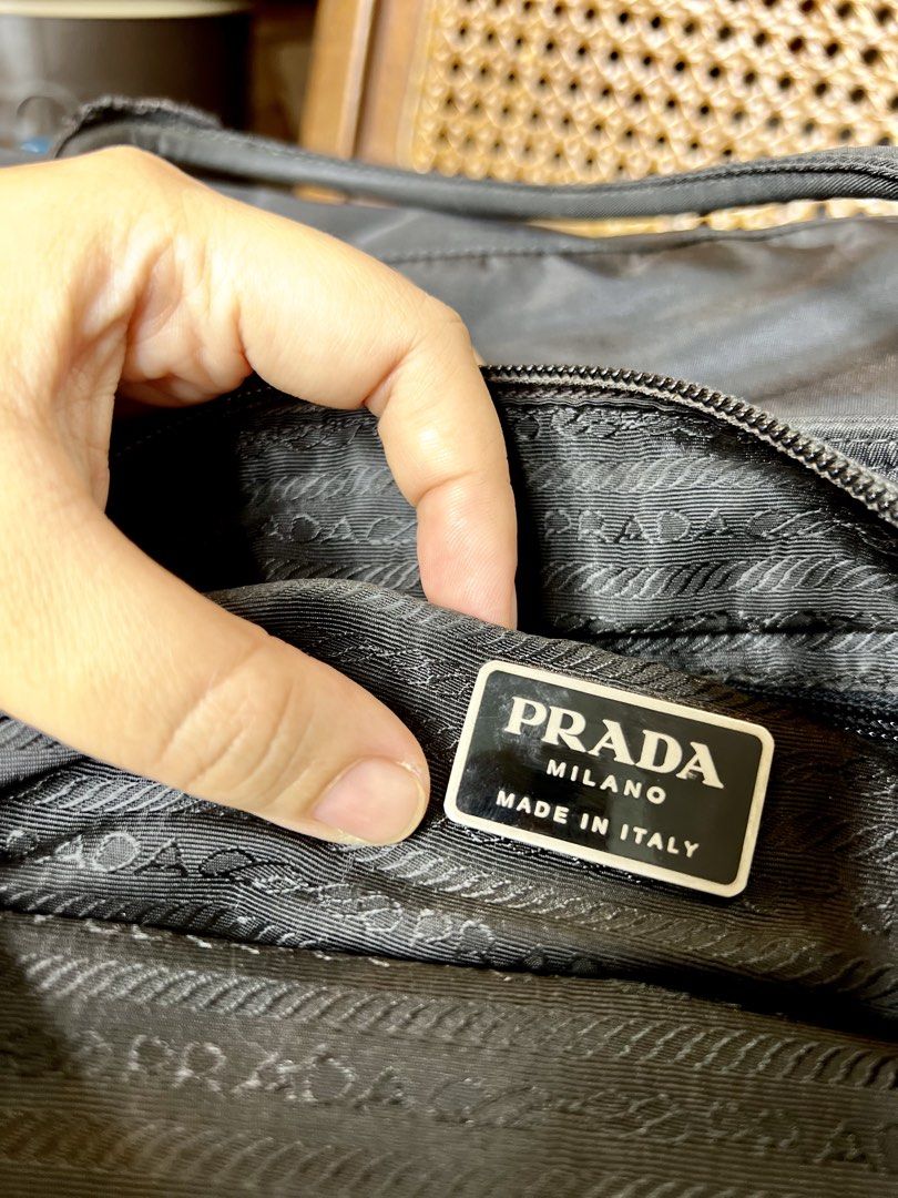 AUTHENTIC PRADA NYLON TOTE BAG (Category: Luxury Bags & Wallets) located in Plaridel. Submitted by dane.thrifts (Listing ID 1444786650, Image 3). Description: - Classic black Prada tote bag - Made in Italy - Durable and lightweight nylon material - Iconic Prada triangle logo on the front - Interior zip pocket - Small tag inside with '52' - Prada branded zipper pull - Great everyday bag.