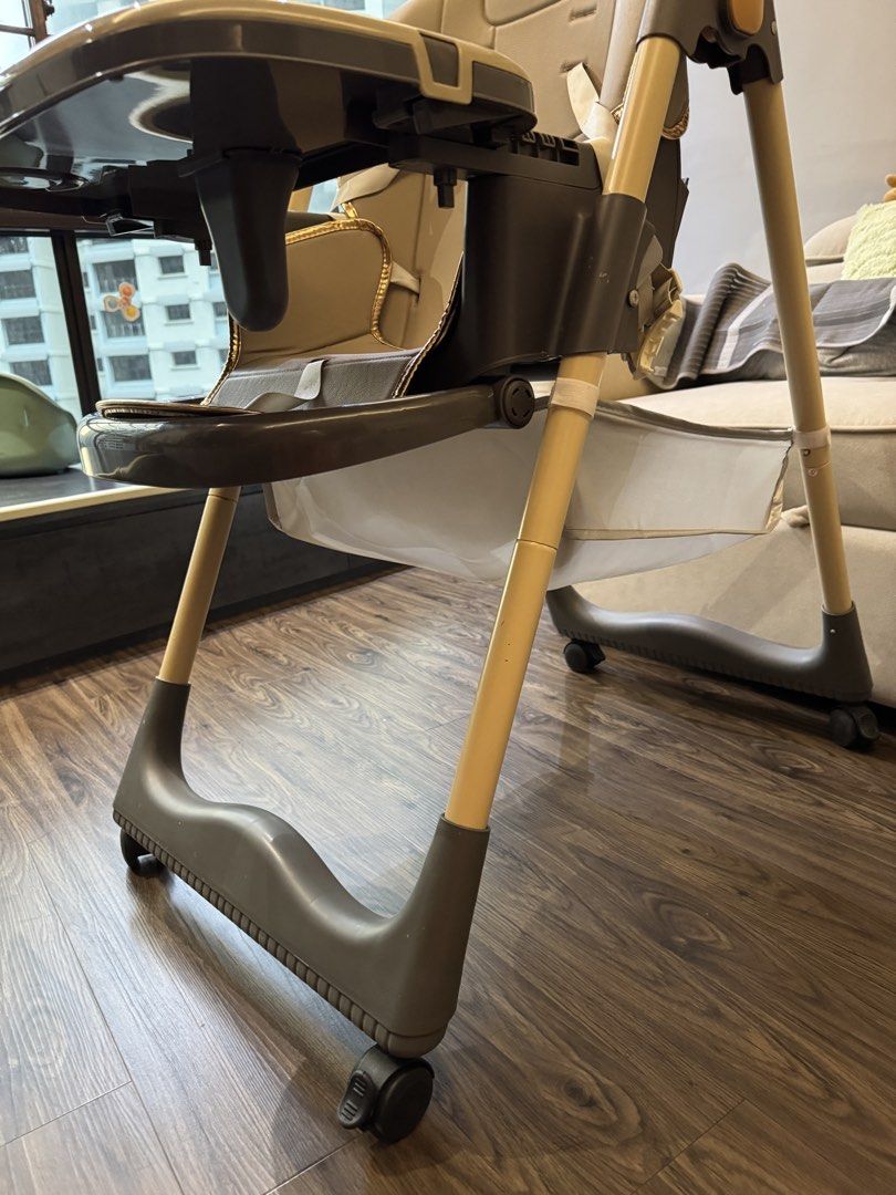 Baby High Chair with Tray and Footrest (Category: Baby High Chairs) located in Singapore. Submitted by hahask (Listing ID 1444856149, Image 1). Description: - Adjustable baby high chair - Removable tray - Footrest included - Safety harness for secure seating - Wheels for easy movement around the house - Neutral beige seat and tray - Light wood tone frame with grey accents - Ideal for meal times.