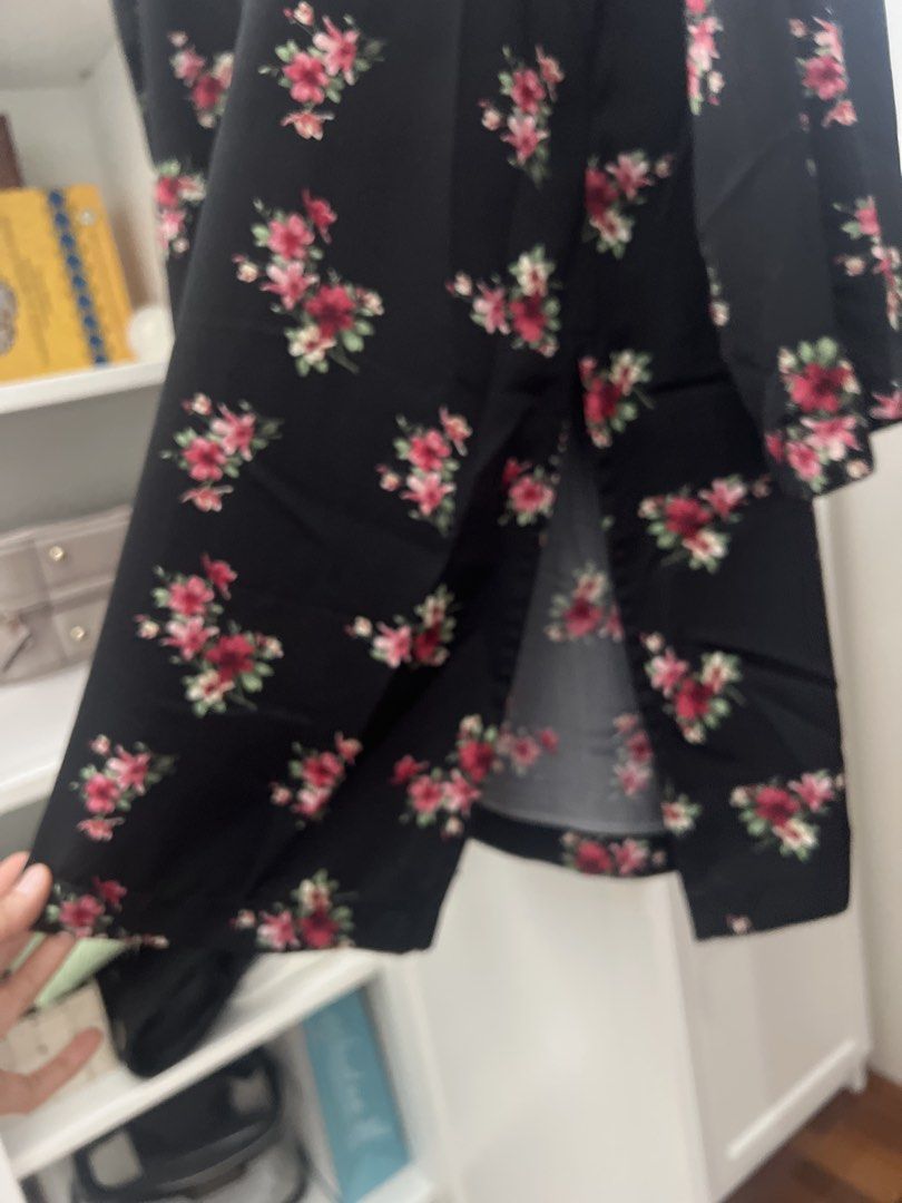 Black Floral V-Neck Button-Up Blouse (Category: Blouses) located in Kuala Lumpur. Submitted by happy_oddriver_e05d34 (Listing ID 1444756308, Image 3). Description: - Black blouse with a charming pink and red floral print. - Features a flattering V-neckline with decorative red buttons down the front. - Long sleeves for versatile styling. - Designed with side slits for a comfortable, relaxed fit. - Perfect for both casual outings and dressing up fo