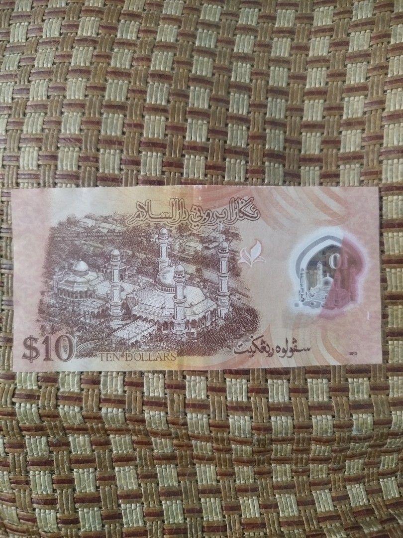 Brunei $10 Ten Dollar Banknote (Category: Currency) located in Subic. Submitted by regiedaniel01 (Listing ID 1444686789, Image 2). Description: - Brunei $10 banknote - Features Sultan of Brunei on the front - Back shows Omar Ali Saifuddien Mosque - Serial number: A/15 15366 - Perfect for collectors.