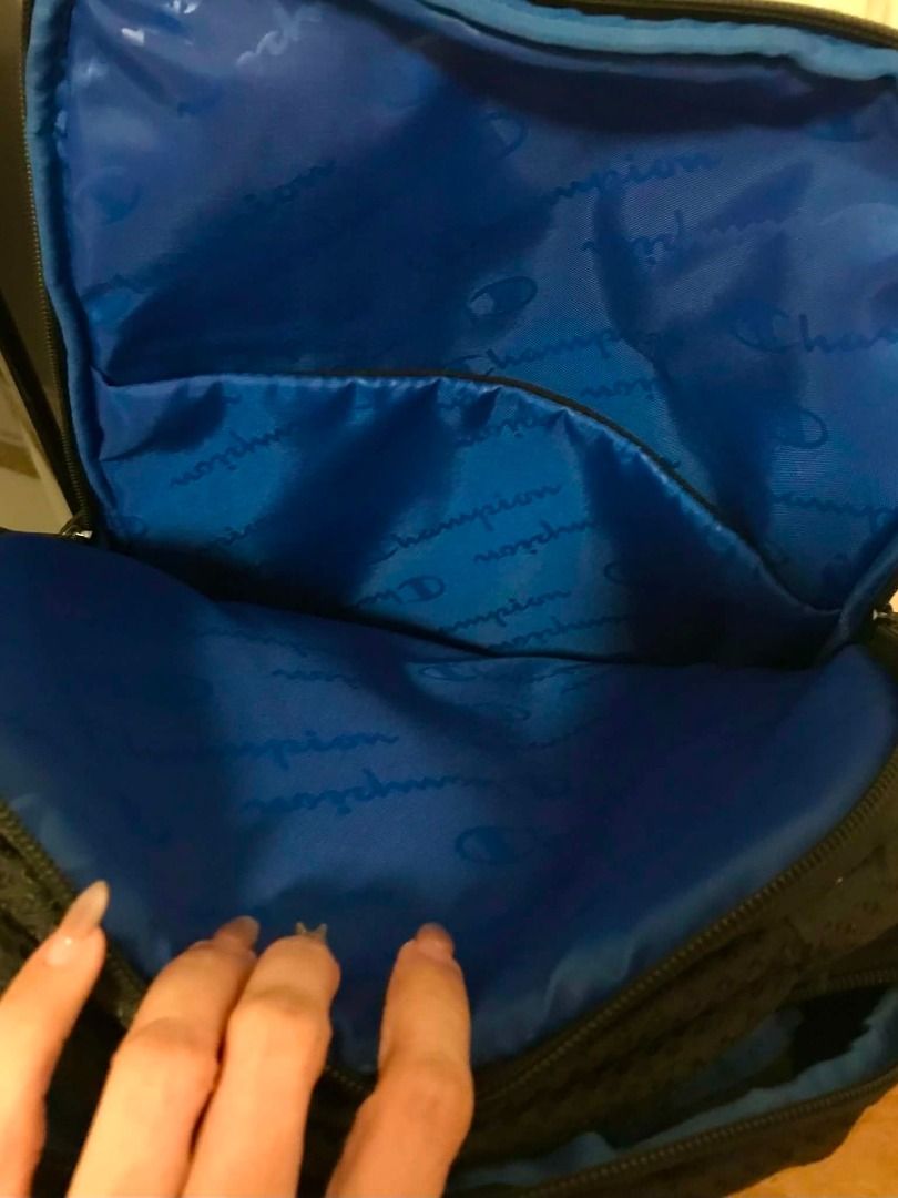 Champion Black Backpack with Blue Interior (Category: Backpacks) located in Manila. Submitted by nate2019 (Listing ID 1444778723, Image 3). Description: - Black Champion backpack - Bought in USA - Bright blue interior with repeated Champion logo - Multiple compartments for organization - Black zippers - Padded back and straps for comfort - Ideal for school or travel - Barely used. Proof is the bottom is without scratch or marks - Shows minimal si
