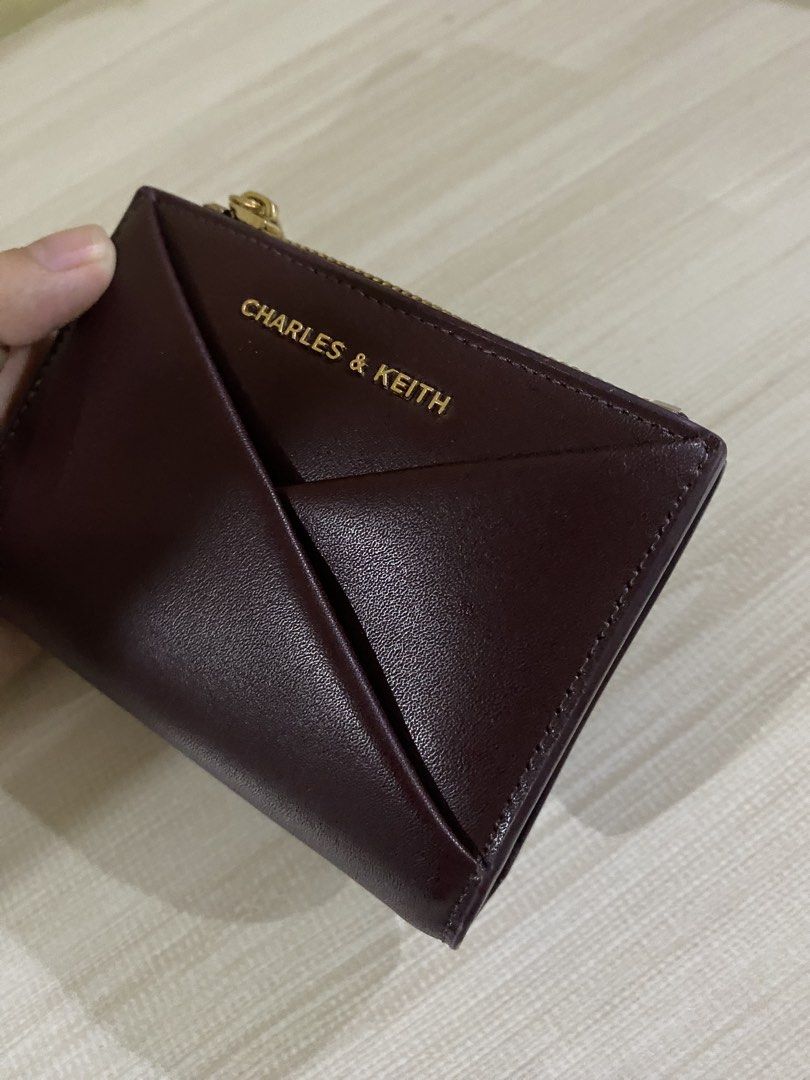 Charles & Keith Burgundy Geometric Tri-fold Wallet (Category: Wallets & Card holders) located in Quezon City. Submitted by xiaolongbaoluvrrr (Listing ID 1444742659, Image 2). Description: • rfs: i’ll buy a new wallet • bought last march • loc: fairview, qc.
