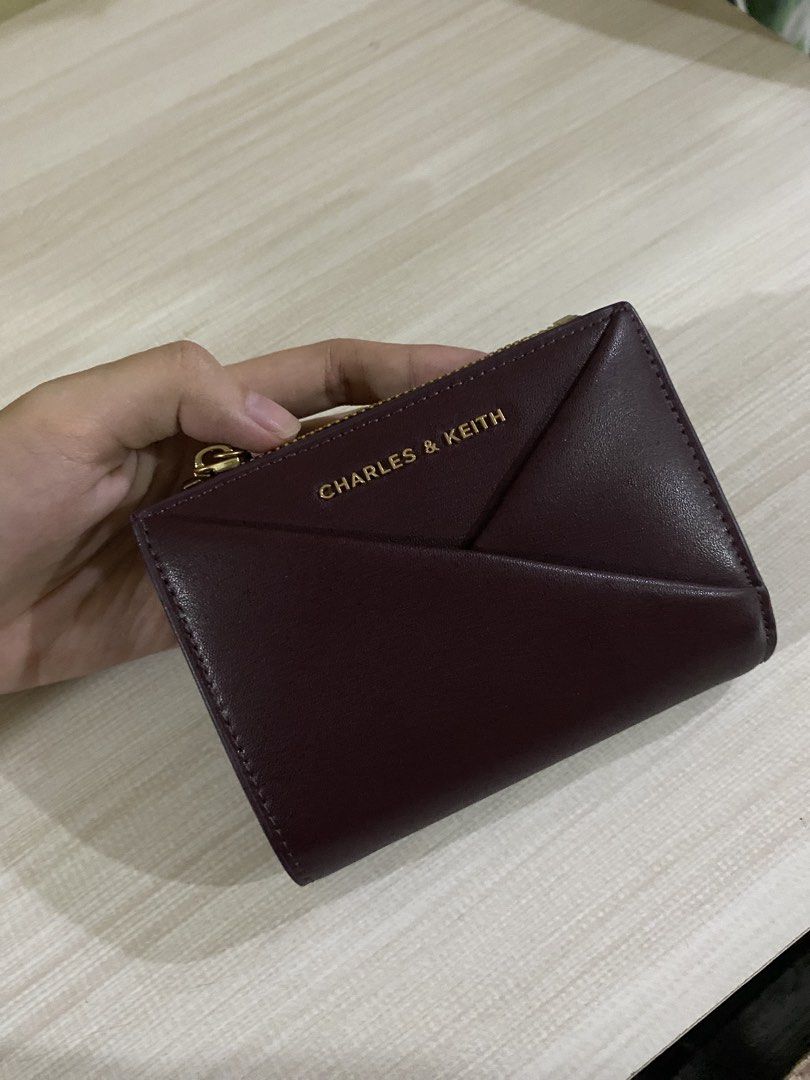 Charles & Keith Burgundy Geometric Tri-fold Wallet (Category: Wallets & Card holders) located in Quezon City. Submitted by xiaolongbaoluvrrr (Listing ID 1444742659, Image 1). Description: • rfs: i’ll buy a new wallet • bought last march • loc: fairview, qc.