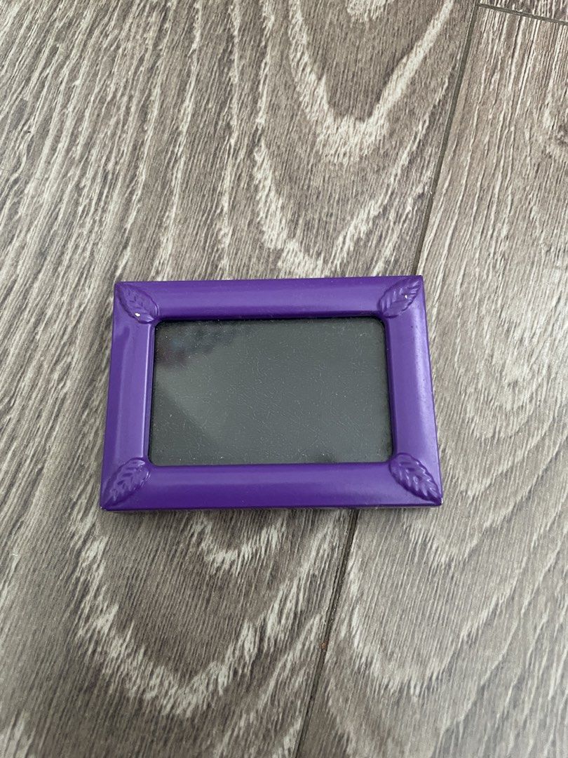 Cute Purple Mini Photo Frame (Category: Frames & Pictures) located in Muntinlupa City. Submitted by ad13zstvff (Listing ID 1444756811, Image 1). Description: - Adorable mini photo frame - Vibrant purple color - Features charming leaf accents on corners - Includes a stand for easy display - Ideal for small photos and desk decor.